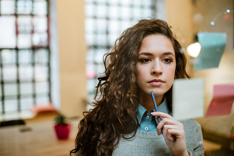 Image of woman at work thinking